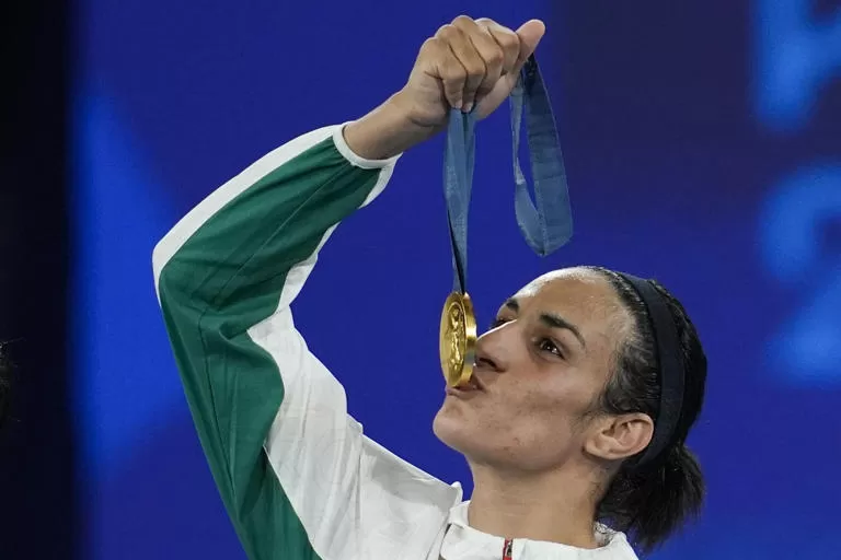 Gold medalist Algeria's Imane Khelif kisses her medal for the women's 66 kg final boxing match at the 2024 Summer Olympics, Friday, Aug. 9, 2024, in Paris, France. (AP Photo/John Locher)