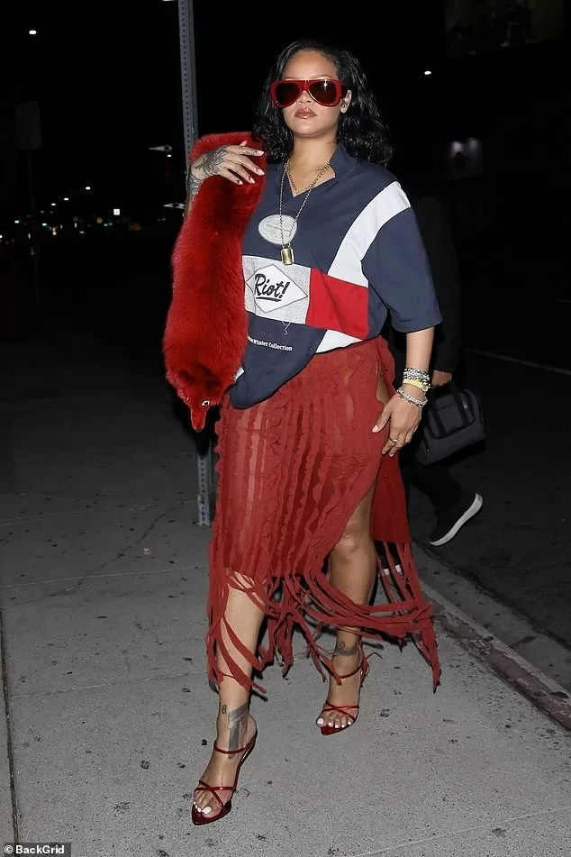 She styled her daring skirt with a navy blue nautical Martine Rose T-shirt that had 'Riot!' written on the front of it ¿ which happens to be her eldest son's name