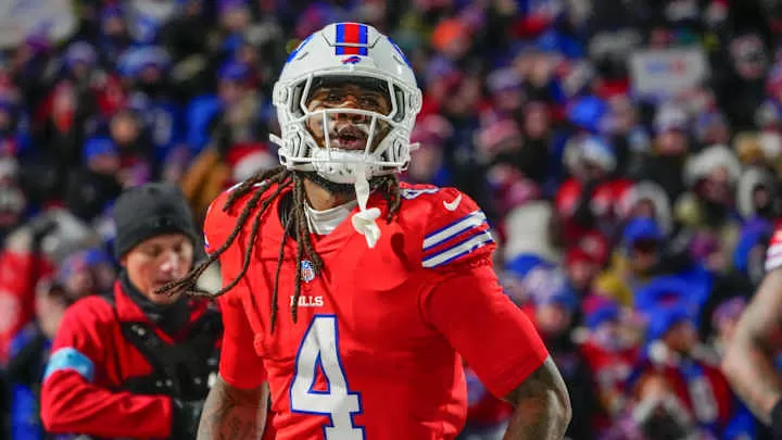 Dec 22, 2024; Orchard Park, New York, USA; Buffalo Bills running back James Cook (4) reacts to scoring a touchdown against the New England Patriots during the first half at Highmark Stadium.