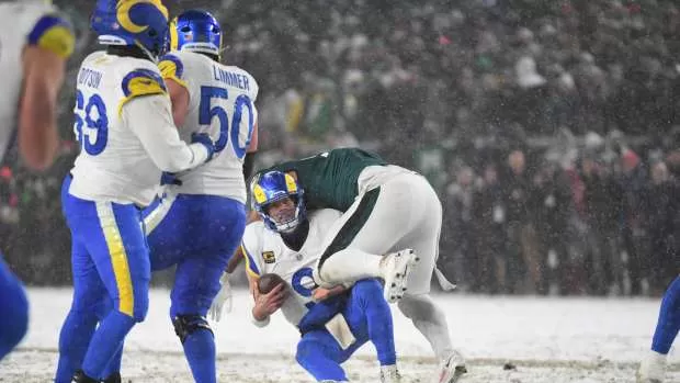 Los Angeles Rams quarterback Matthew Stafford (9) is sacked by Philadelphia Eagles defensive tackle Jalen Carter (98) during the fourth quarter in a 2025 NFC divisional round game at Lincoln Financial Field.