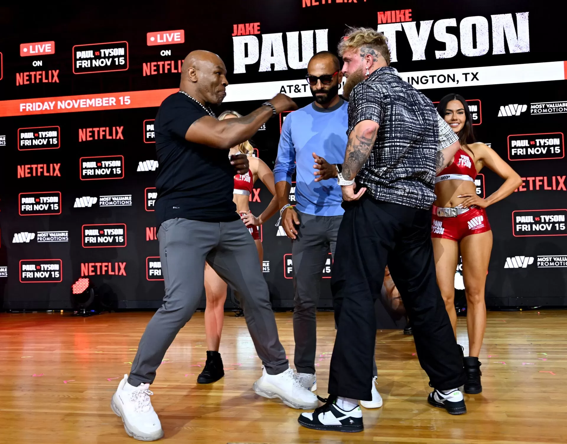 Mike Tyson throws a punch and pushes Jake Paul during heated face-off as  boxing fight is rescheduled