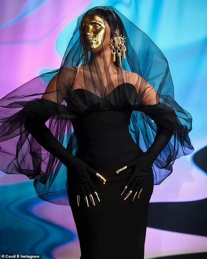 Cardi B Shocks When Cosmetics Wears Gold Mask