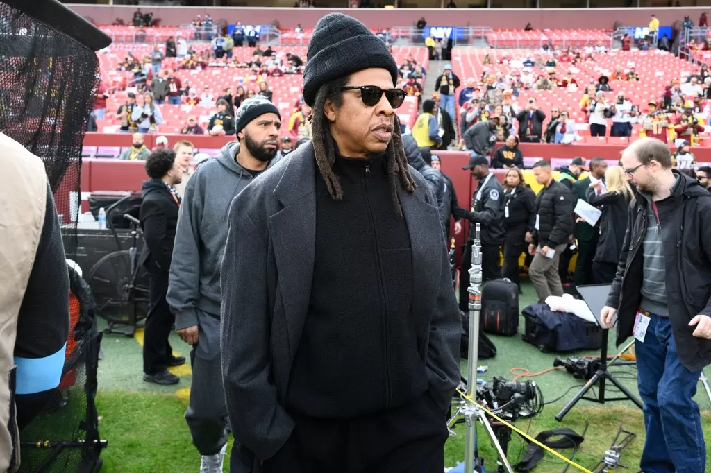 Jay-Z stands on the field before an NFL football game between the Washington Commanders and Dallas Cowboys, Sunday, Nov. 24, 2024