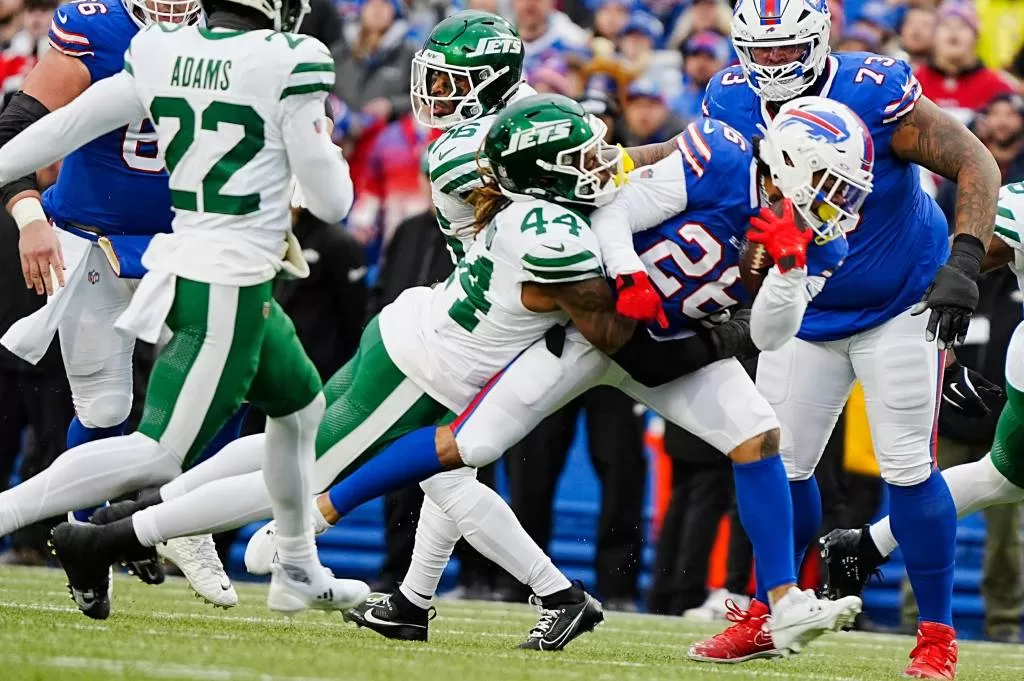 Jets linebacker Jamien Sherwood tackles Bills running back Ty Johnson on Sunday in Orchard Park.