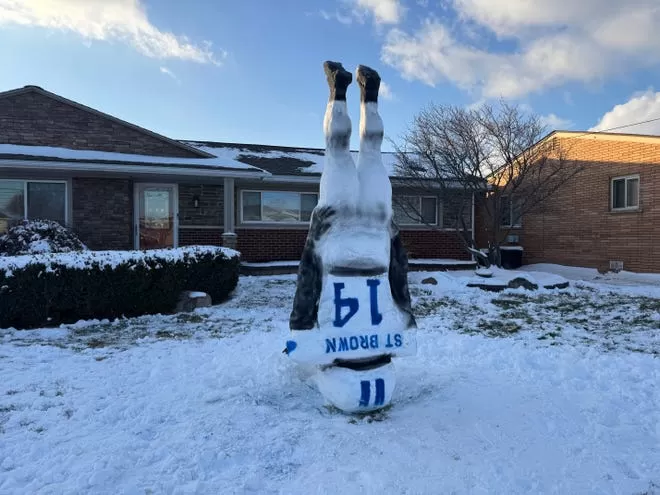A snowman shaped like Detroit Lions wide receiver Amon-Ra St. Brown's iconic headstand touchdown celebration, built by Jamison Agnello, a Harrison Township resident, on Saturday, Jan. 11, 2025.