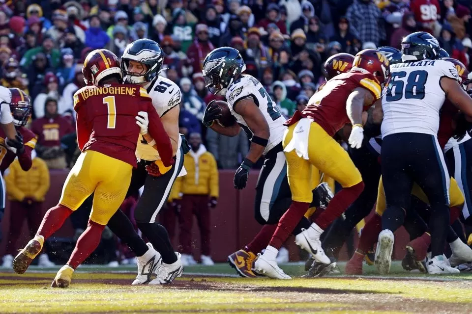 Dec 22, 2024; Landover, Maryland, USA; Philadelphia Eagles running back Saquon Barkley (26) runs to a touchdown during the first quarter against the Washington Commanders at Northwest Stadium. Mandatory Credit: Peter Casey-Imagn Images