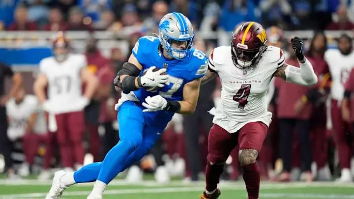 Detroit Lions tight end Sam LaPorta (87) looks for yards against Washington Commanders linebacker Frankie Luvu (4) in the first quarter against in the NFC divisional round at Ford Field in Detroit on Saturday, Jan. 18, 2025.