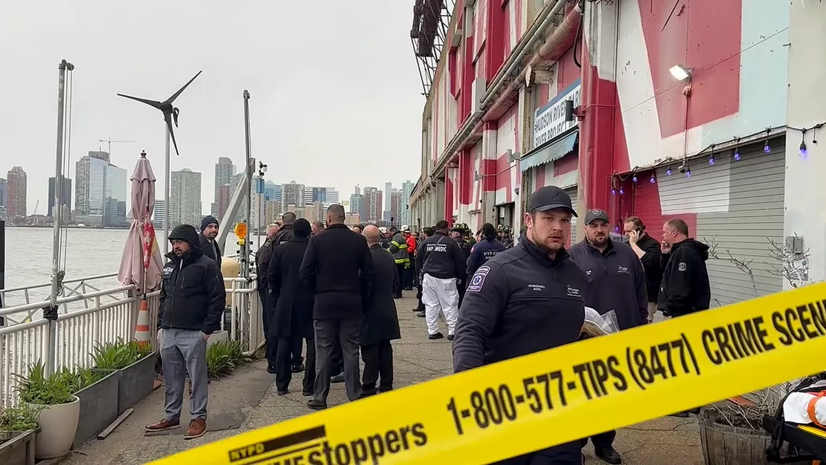 Crime scene where first responders walk along Pier 40 where the helicopter crashed
